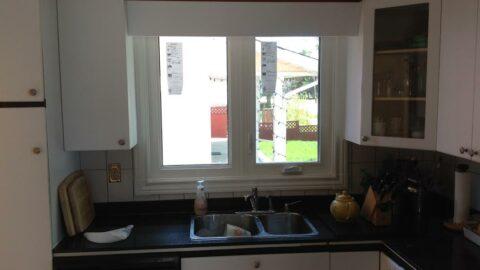 A kitchen window with cut casings
