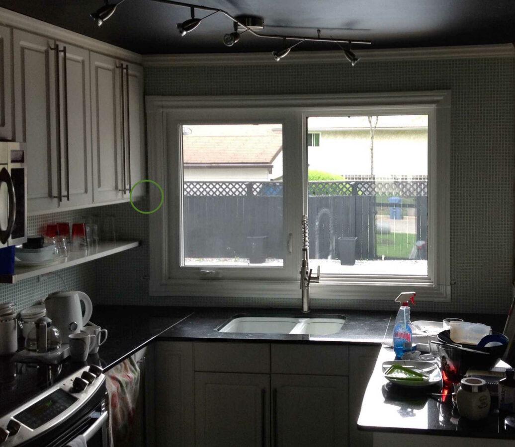 A kitchen slider window with casing