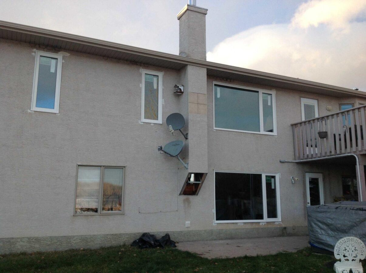 House windows with patched stucco