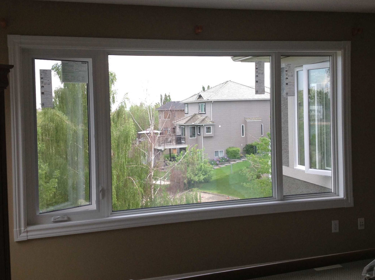 A high-profile casement window with two low-profile fixed windows.