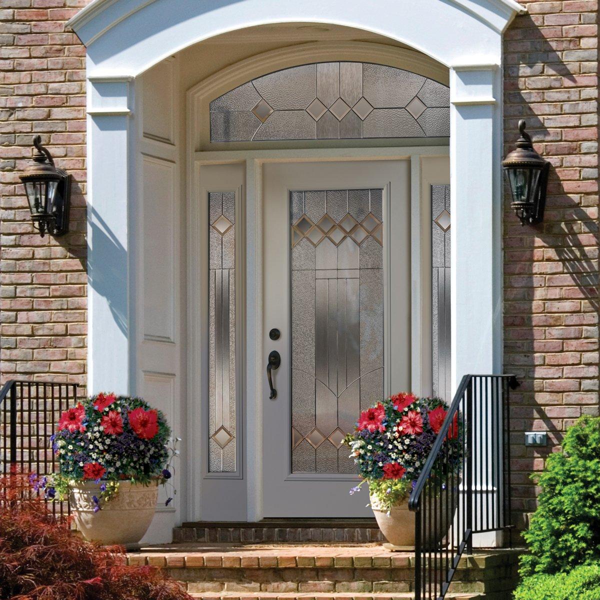 White steel door with sidelights and transom, inserts of decorative glass with grids.